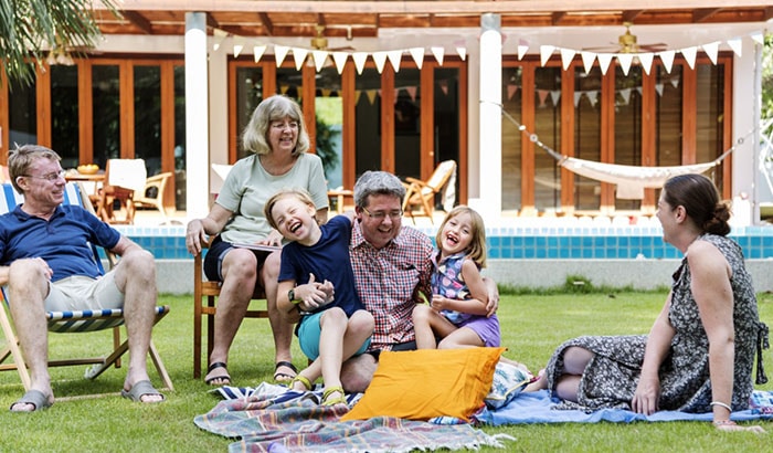 Family enjoying picnic in backyard